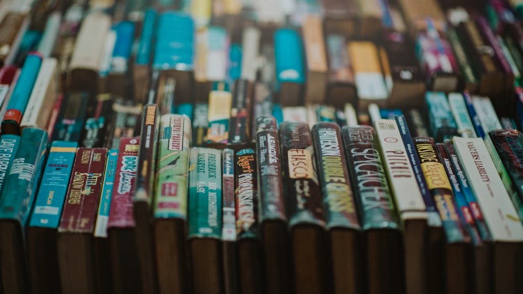 Close-up of various books on a shelf showcasing an array of titles and genres.